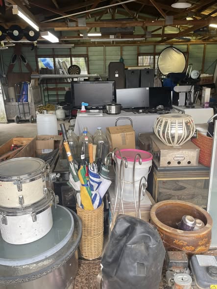 Inside the shed: drums, umbrellas, baskets, baby buckets