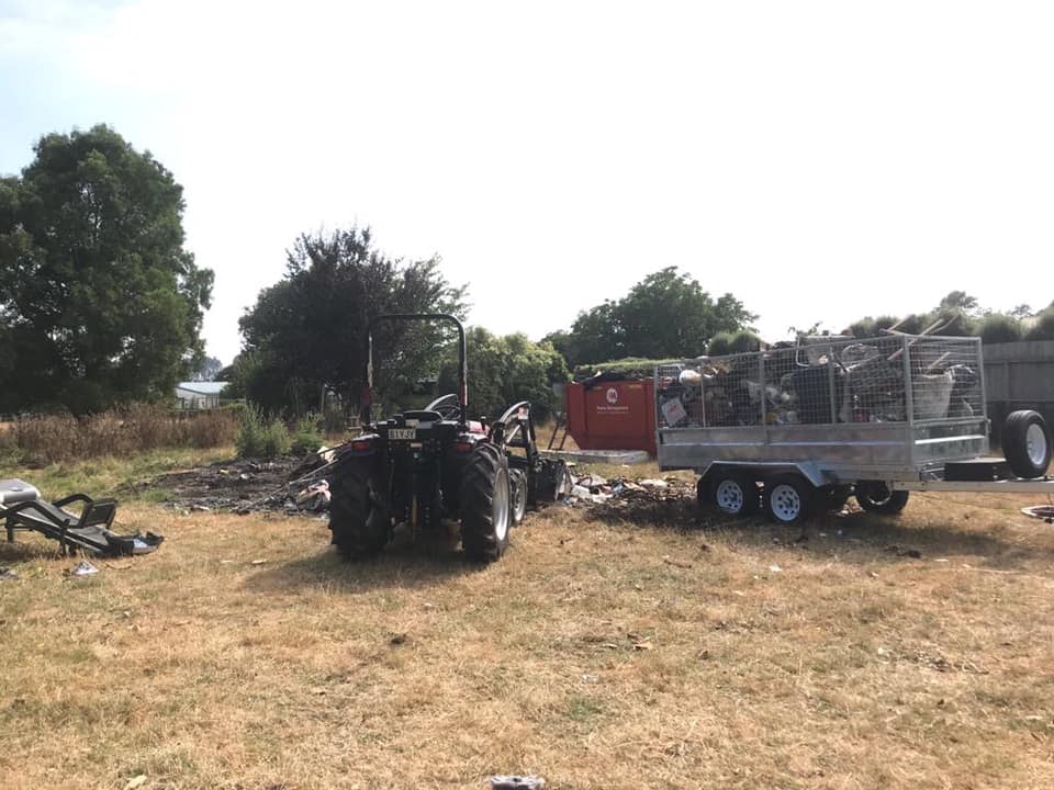 Tractor towing a cage trailer of inorganic waste